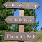 A post with wooden signs point the way to three different Sravasti Abbey forest paths.