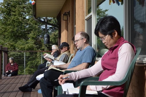 Guest read Dharma books on the Chenrezig Hall deck.