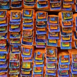 A shelf of Tibetan religious texts wrapped in cloth.