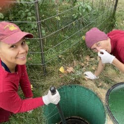 Venerables Kunga and Dekyi clean the septic system with joy.