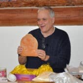 Dr. Guy Newland holds a Manjushri tsatsa.