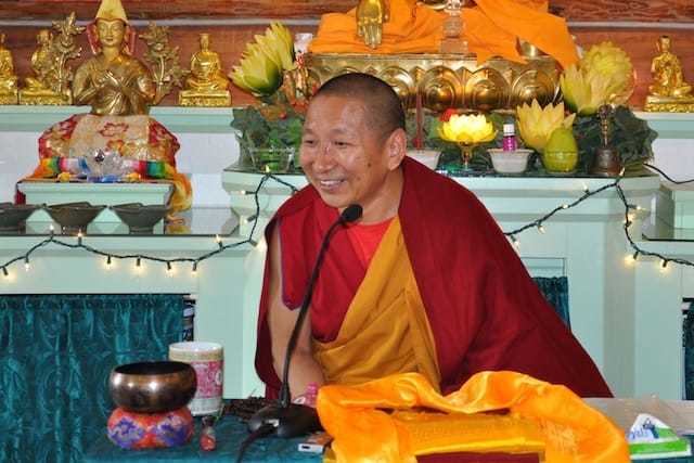 Geshe Yeshi Lhundup smiles while teaching in the Meditation Hall.