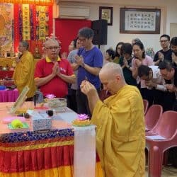 Venerable Chodron offers incense before giving a talk at Pureland Marketing in Singapore.