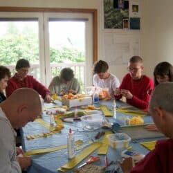 Exploring Monastic Life participants roll mantras together.