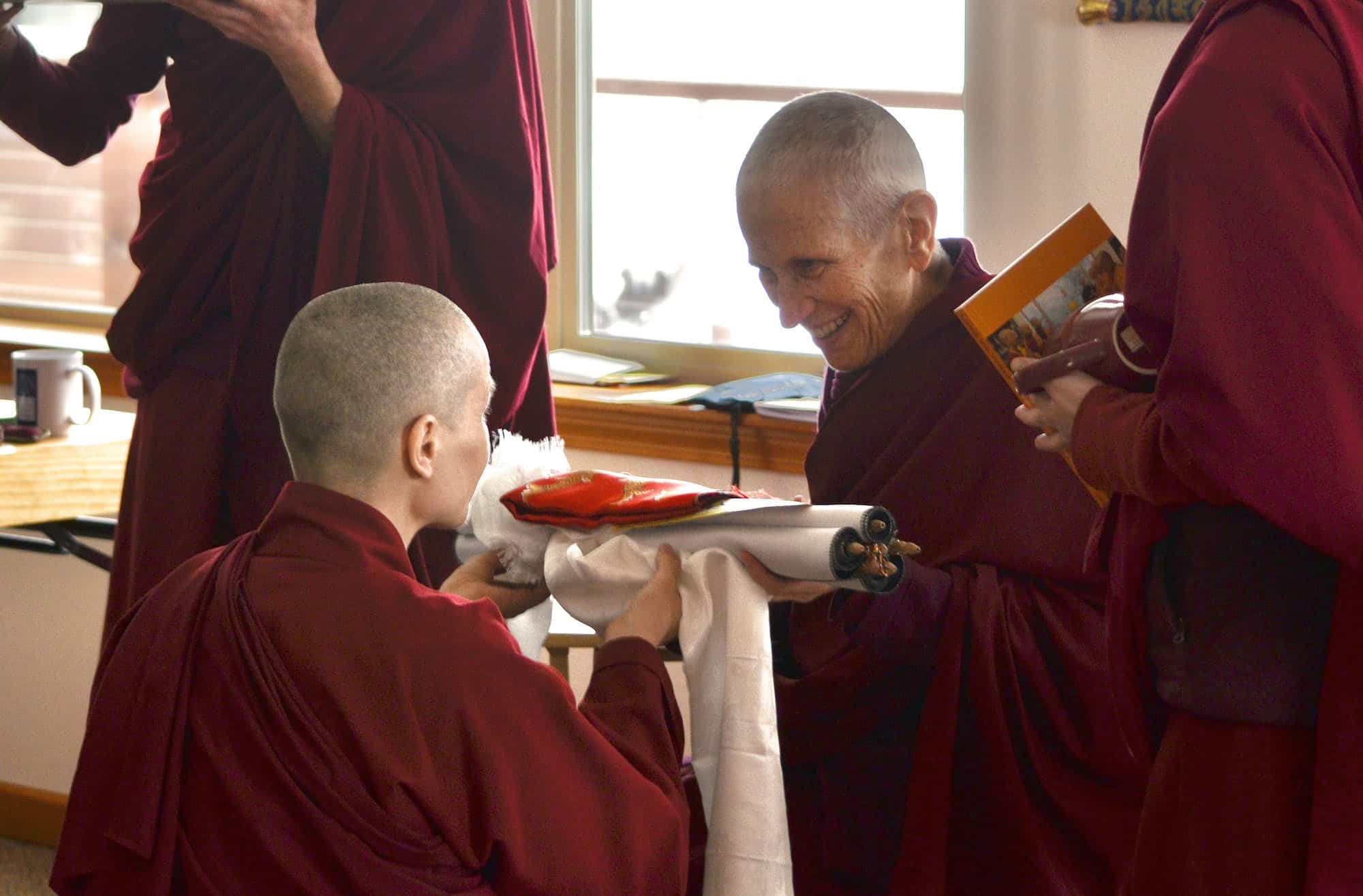 Buddhist nun making an offering to her teacher.